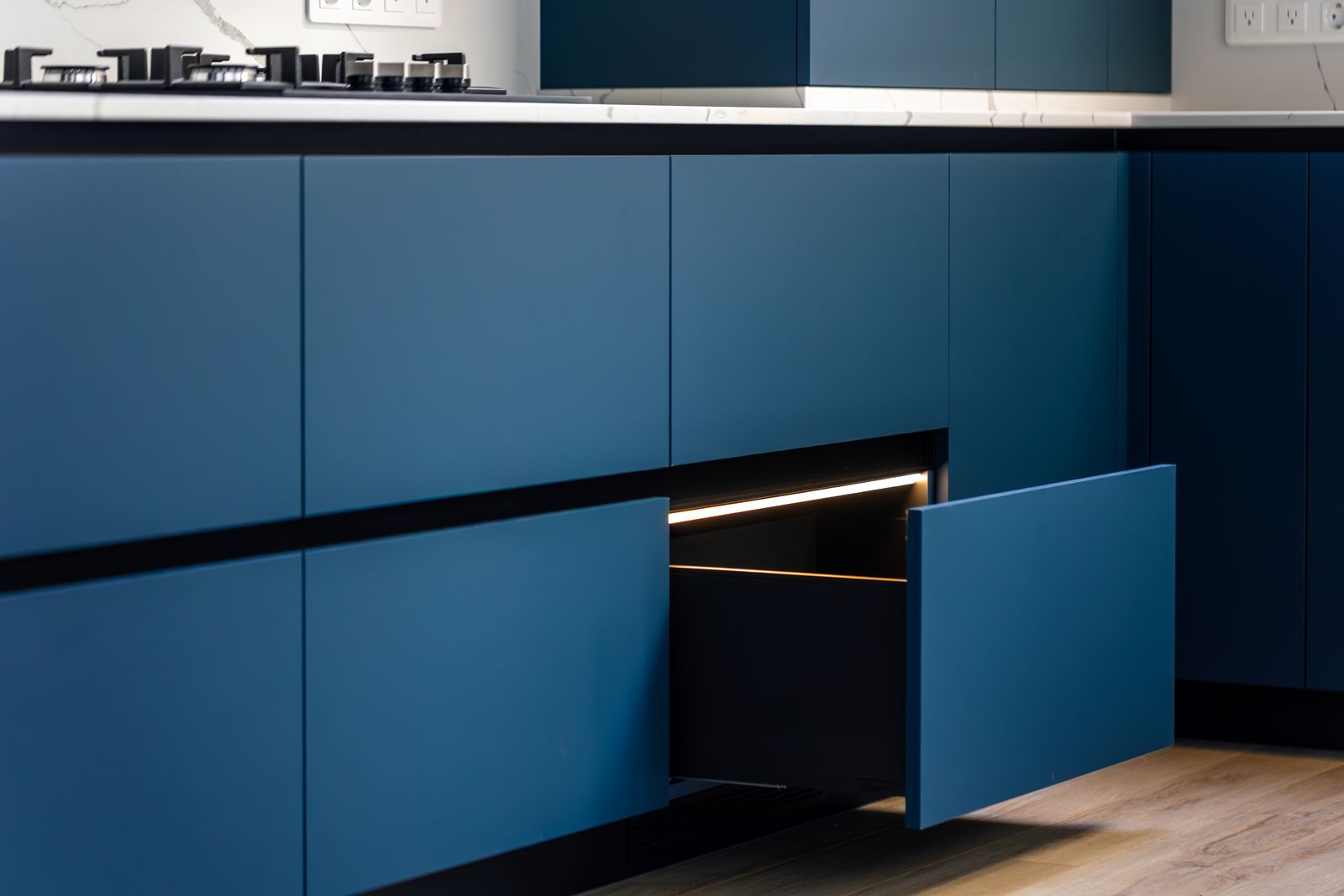 Freshly painted matte blue kitchen cabinets in a modern Lakewood Ranch home